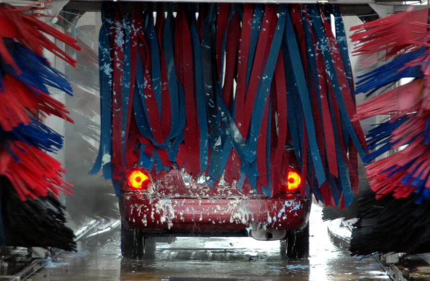 Car moving through an automated express car wash tunnel