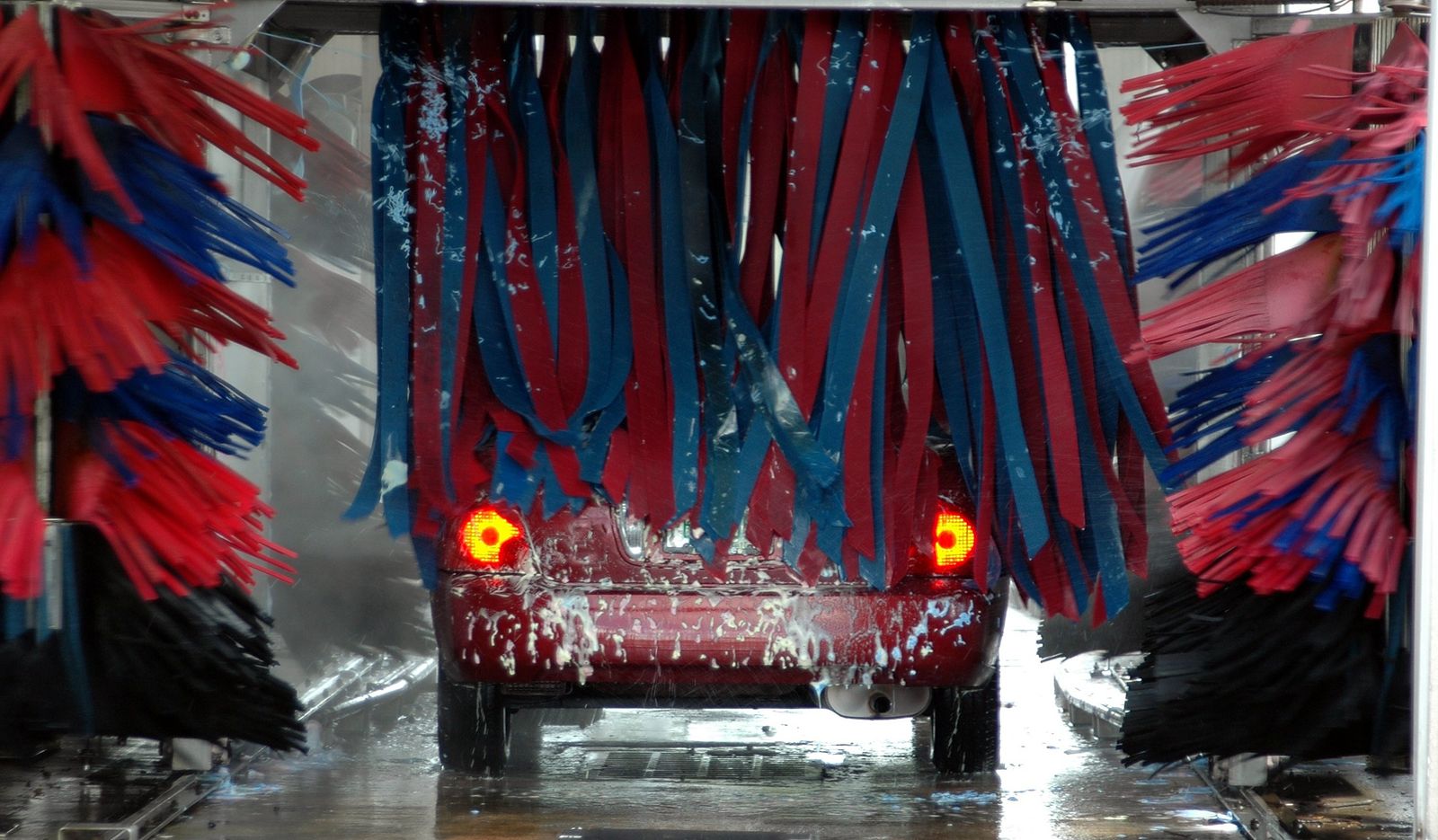 Car moving through an automated express car wash tunnel